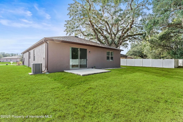 rear view of house with a patio, a yard, and cooling unit