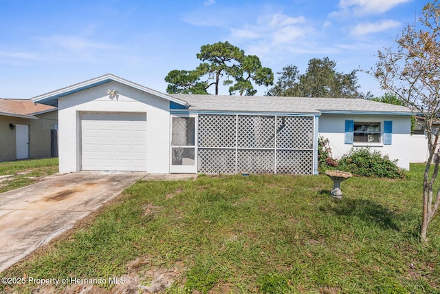 single story home featuring a garage and a front lawn