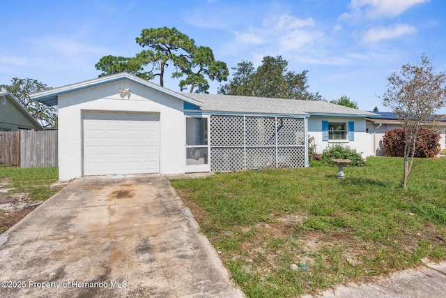 single story home featuring a garage and a front lawn