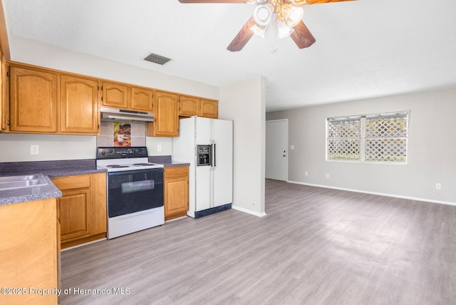 kitchen with ceiling fan, white appliances, and light hardwood / wood-style flooring