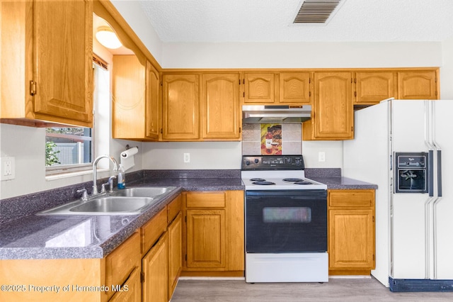 kitchen featuring electric stove, sink, white fridge with ice dispenser, a textured ceiling, and light wood-type flooring