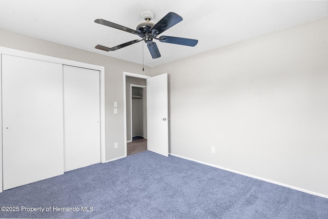 unfurnished bedroom with ceiling fan, carpet floors, and a closet