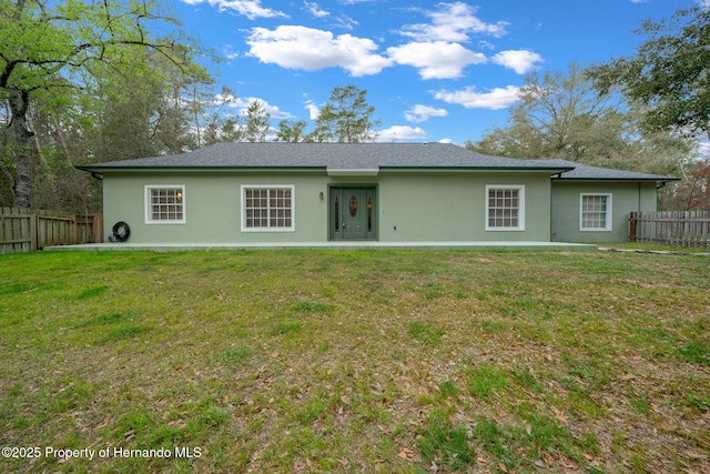 rear view of house with a patio area and a lawn