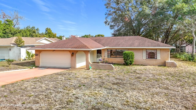 single story home featuring a garage and a front lawn