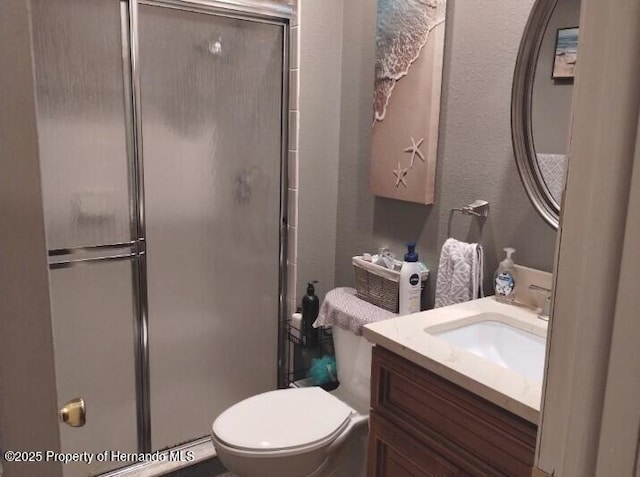 bathroom featuring vanity, toilet, and walk in shower