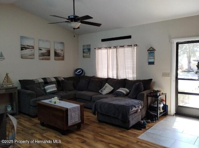 living room featuring vaulted ceiling, plenty of natural light, hardwood / wood-style floors, and ceiling fan