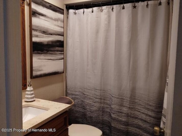 bathroom featuring vanity and toilet