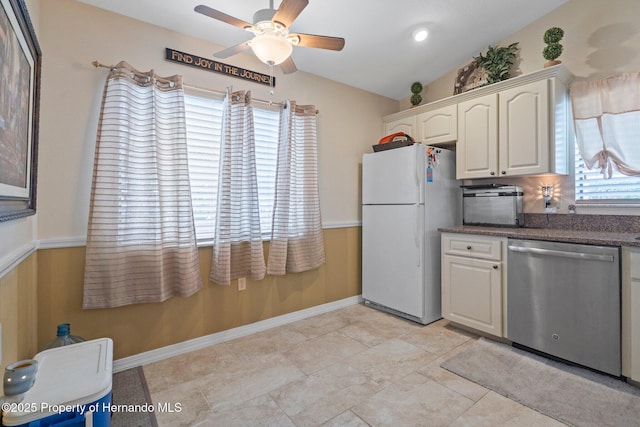 kitchen with lofted ceiling, white refrigerator, stainless steel dishwasher, ceiling fan, and white cabinets