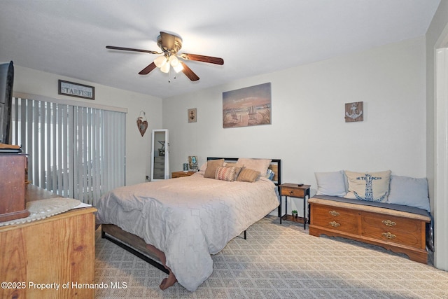 bedroom with light carpet and ceiling fan