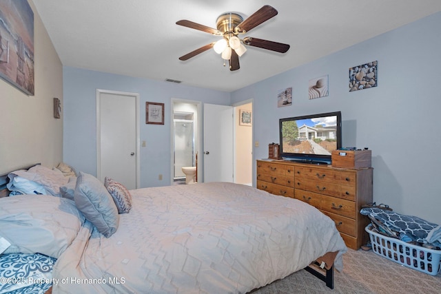 carpeted bedroom with ceiling fan and ensuite bathroom