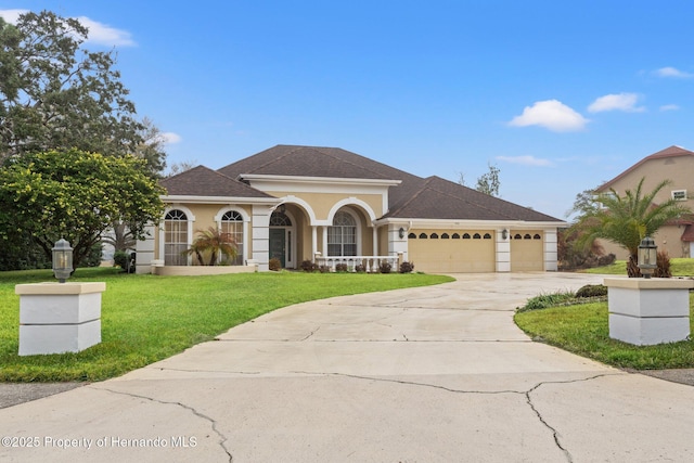 mediterranean / spanish house with a garage and a front yard