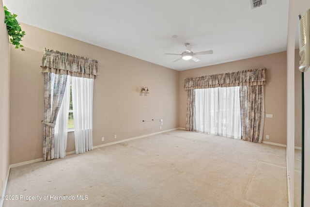 4412 Lake In The Woods Dr, Spring Hill, FL 34607 - carpeted empty room with visible vents, baseboards, a ceiling fan, and a healthy amount of sunlight