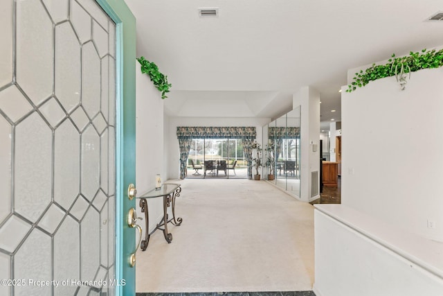 4412 Lake In The Woods Dr, Spring Hill, FL 34607 - entryway featuring visible vents, baseboards, and carpet flooring