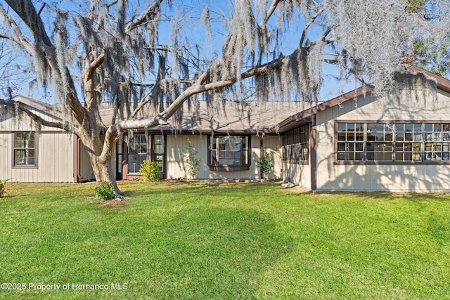 rear view of house with a yard