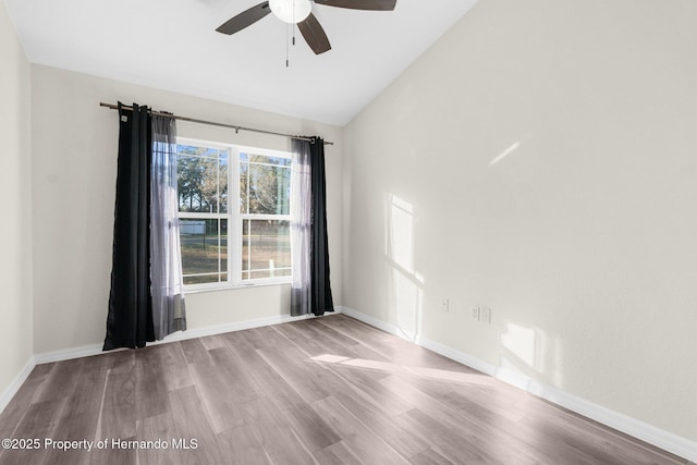 unfurnished room with vaulted ceiling, ceiling fan, and light hardwood / wood-style flooring