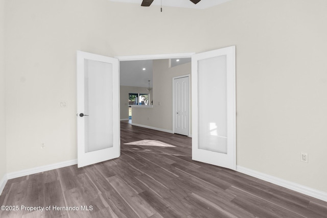 unfurnished room with dark wood-type flooring, ceiling fan, and french doors