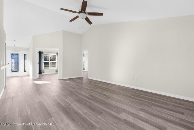 unfurnished living room with high vaulted ceiling, hardwood / wood-style floors, and ceiling fan