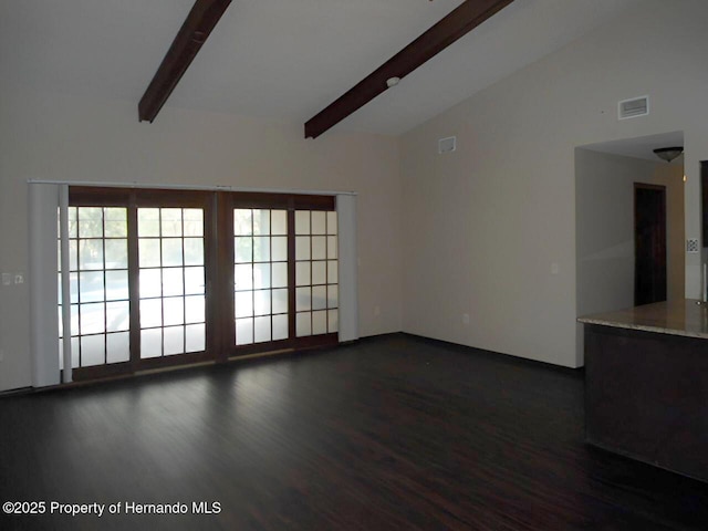 unfurnished living room featuring lofted ceiling with beams and dark hardwood / wood-style floors