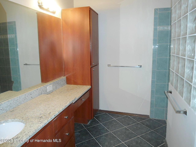 bathroom with tile patterned flooring and vanity