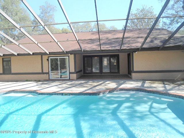 view of swimming pool featuring a lanai and a patio area