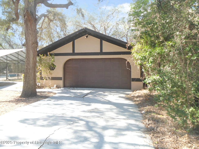 view of front of property with a garage and a lanai