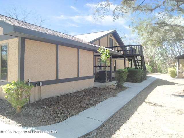 view of side of property featuring a wooden deck