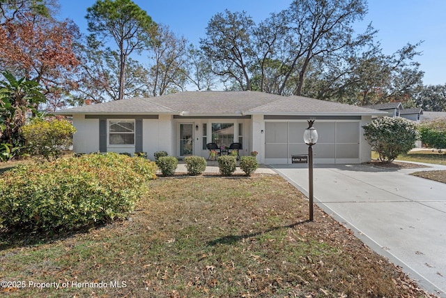 ranch-style home featuring a garage, a front yard, and a porch