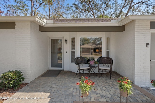 entrance to property with a patio