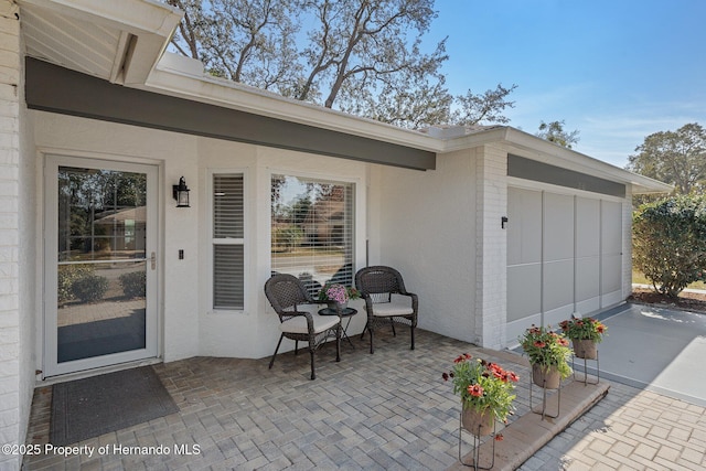 view of exterior entry featuring a patio