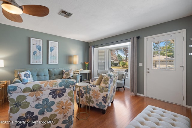 living room featuring hardwood / wood-style floors and a textured ceiling