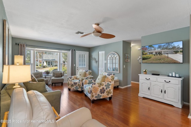 living room with hardwood / wood-style flooring and ceiling fan