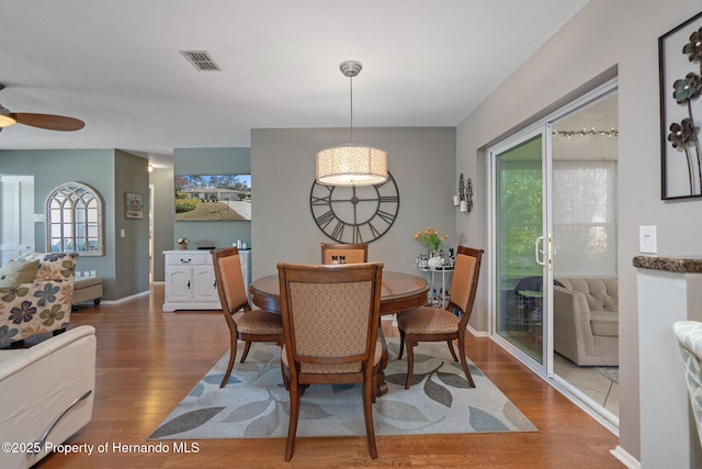 dining area with hardwood / wood-style flooring, a healthy amount of sunlight, and ceiling fan