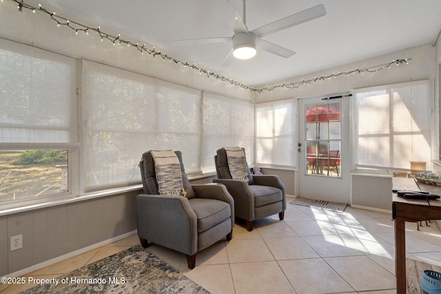 sitting room featuring light tile patterned flooring and ceiling fan