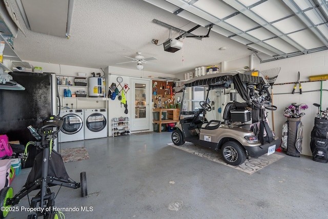 garage featuring water heater, a garage door opener, and independent washer and dryer