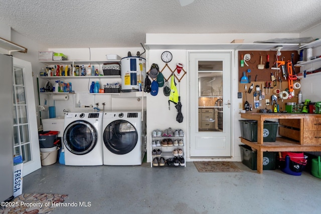 garage with separate washer and dryer, a workshop area, and water heater