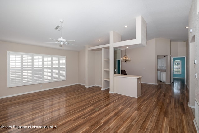 unfurnished living room with dark hardwood / wood-style flooring and ceiling fan with notable chandelier