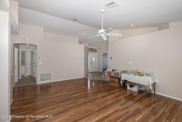 unfurnished room featuring high vaulted ceiling, dark hardwood / wood-style floors, and ceiling fan