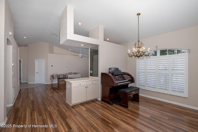 kitchen featuring decorative light fixtures, white cabinetry, dark wood-type flooring, and kitchen peninsula