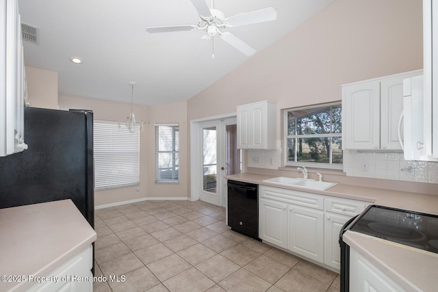 kitchen featuring white cabinetry, decorative light fixtures, sink, and black appliances