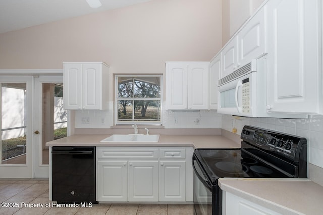 kitchen featuring tasteful backsplash, white cabinetry, sink, and black appliances