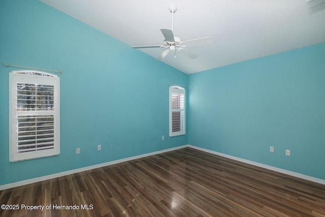 spare room with dark hardwood / wood-style flooring, lofted ceiling, and ceiling fan