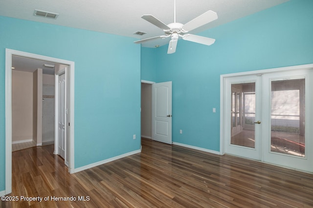 unfurnished bedroom with high vaulted ceiling, access to outside, ceiling fan, dark wood-type flooring, and french doors