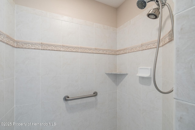 bathroom with a tile shower