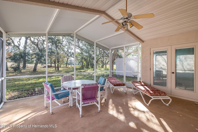 sunroom / solarium with ceiling fan and vaulted ceiling