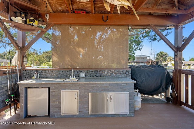 view of patio with an outdoor kitchen and area for grilling