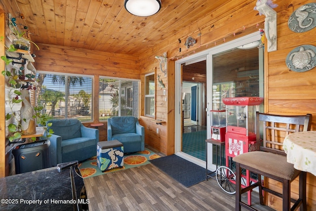 sunroom featuring a healthy amount of sunlight and wooden ceiling