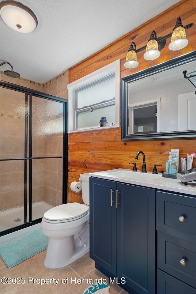 bathroom with vanity, a shower with shower door, and tile patterned flooring