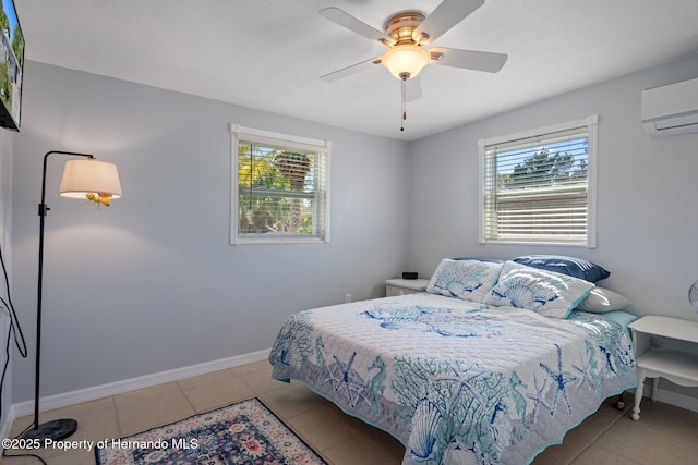 tiled bedroom with ceiling fan and a wall mounted AC