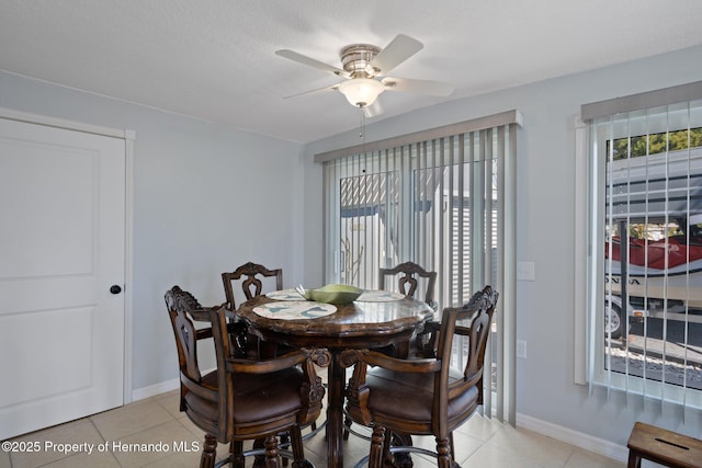 tiled dining area featuring ceiling fan and a healthy amount of sunlight