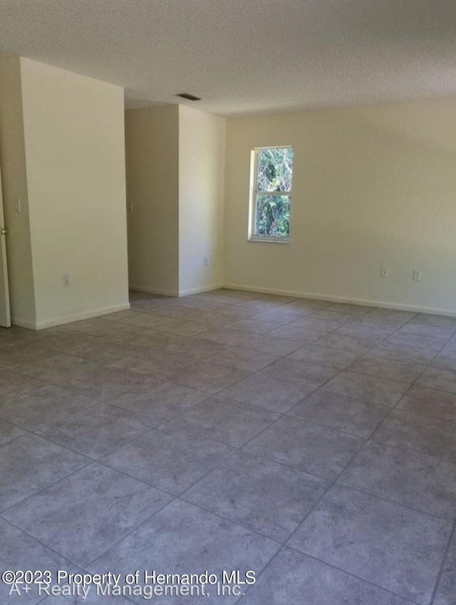 empty room featuring a textured ceiling